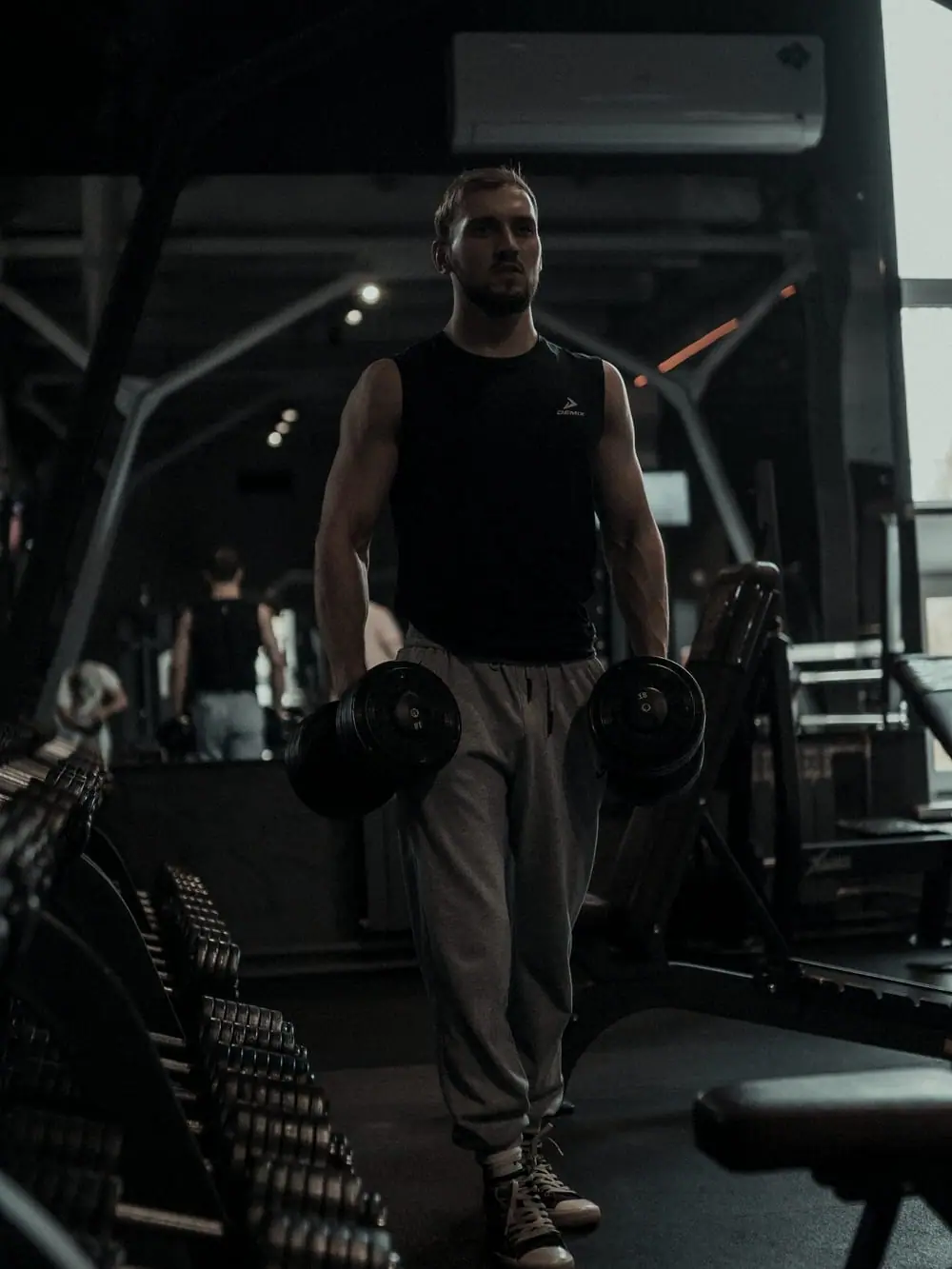 Julien Mercier in a darkened gym under a single directional light.